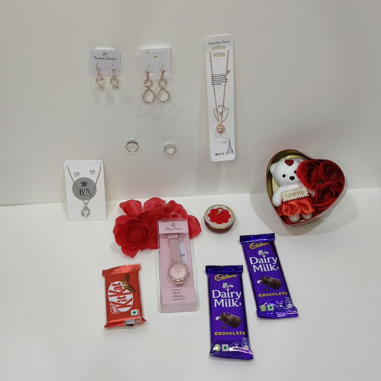 combo gift pack including taddy, 3 Rose sets, watch, 2 sets niklace , 3 sets ring , 2 dairy milk chocolate,  kitkat ,